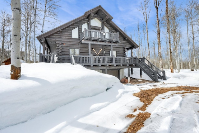 4100 Buck Way Unit 1947, Heber City, UT 84032 - snow covered property featuring log exterior, stairs, a garage, and a balcony