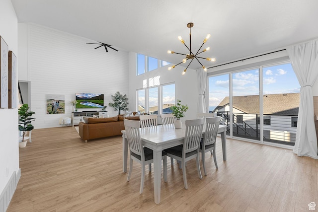 3248 S Forest Ave, Saratoga Springs, UT 84045 - dining room featuring a chandelier, light wood-type flooring, a high ceiling, and visible vents