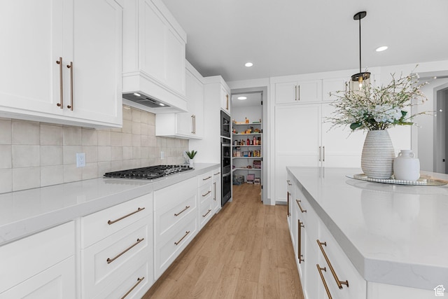3248 S Forest Ave, Saratoga Springs, UT 84045 - kitchen featuring light wood-type flooring, appliances with stainless steel finishes, white cabinetry, recessed lighting, and decorative backsplash