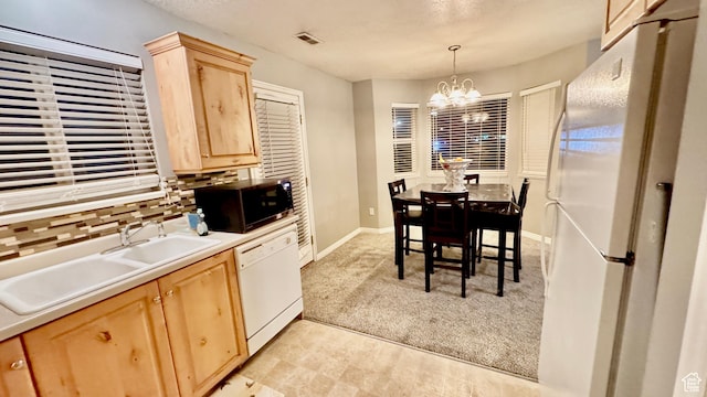 70 Teal Loop, Logan, UT 84321 - kitchen with visible vents, a notable chandelier, light brown cabinets, a sink, and white appliances