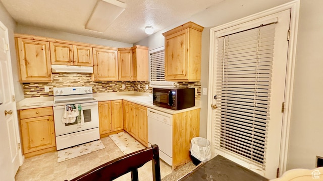 70 Teal Loop, Logan, UT 84321 - kitchen featuring white appliances, under cabinet range hood, light countertops, light brown cabinets, and backsplash