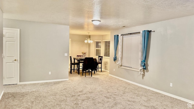 70 Teal Loop, Logan, UT 84321 - carpeted dining room featuring baseboards, a textured ceiling, and an inviting chandelier