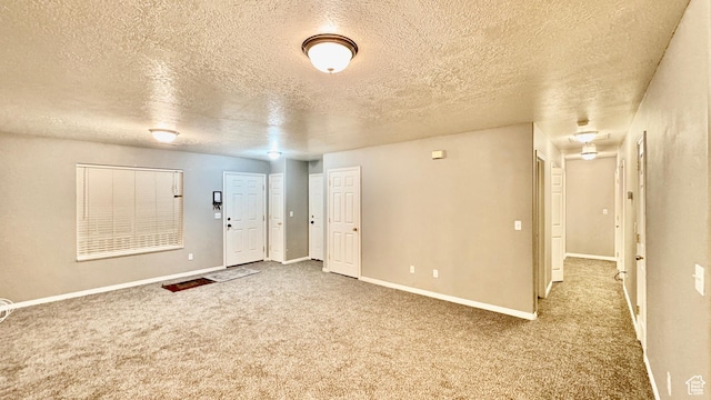 70 Teal Loop, Logan, UT 84321 - foyer with a textured ceiling, baseboards, and carpet floors