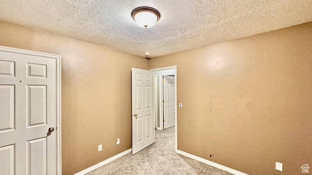 70 Teal Loop, Logan, UT 84321 - empty room with a textured ceiling, light colored carpet, and baseboards