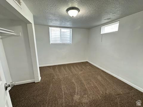 unfurnished bedroom featuring baseboards, carpet, and a textured ceiling