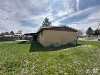 view of side of home featuring a lawn