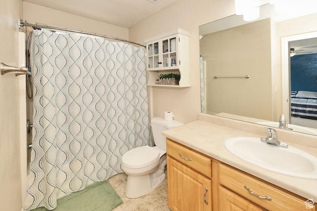 ensuite bathroom with a shower with shower curtain, vanity, connected bathroom, and toilet