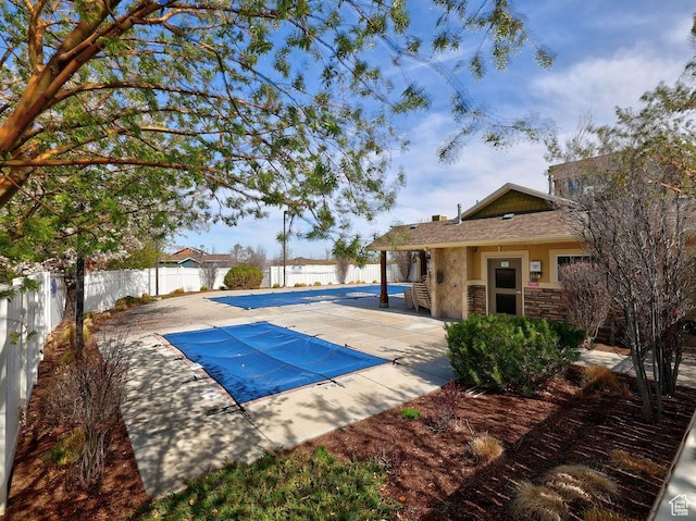 view of basketball court with a fenced backyard and a fenced in pool