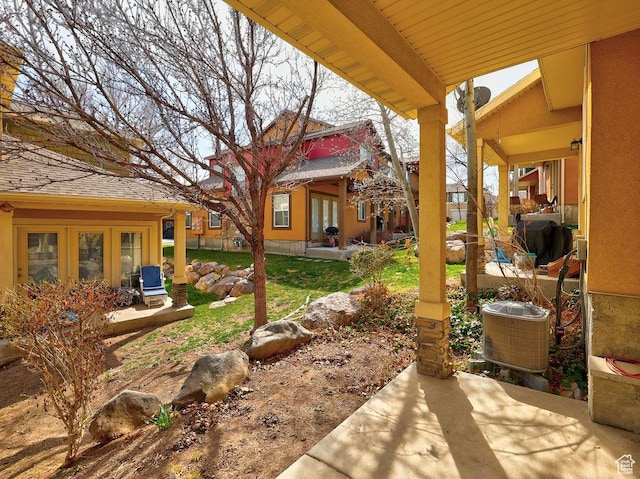 view of yard featuring a patio area and french doors