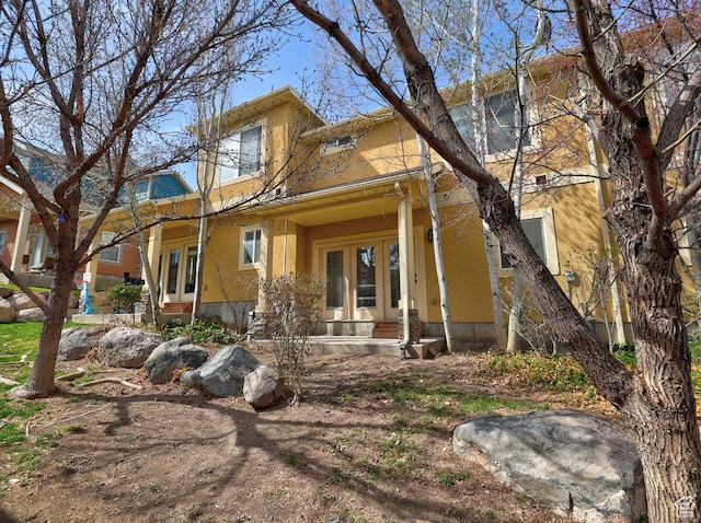 view of front of property featuring french doors and stucco siding