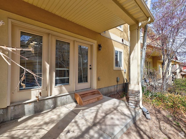 entrance to property featuring stucco siding