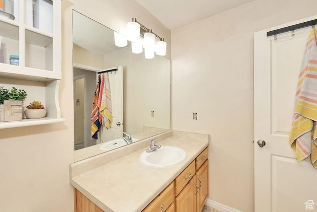 bathroom with baseboards and vanity