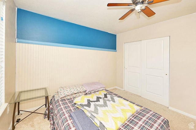 bedroom with carpet, a closet, baseboards, and ceiling fan