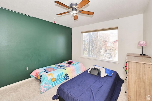 bedroom with baseboards, a ceiling fan, and carpet