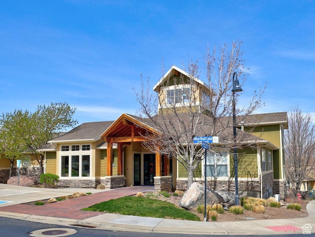 craftsman-style home featuring stone siding