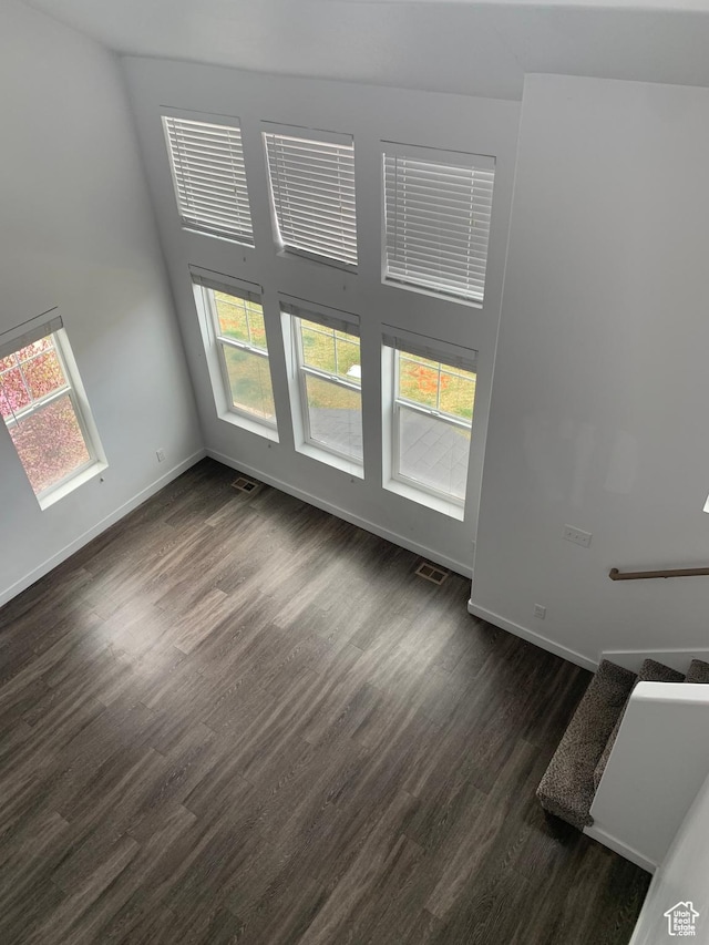 interior space featuring dark wood-style floors, baseboards, and visible vents