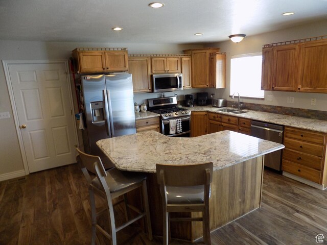 475 W 100 N, Aurora, UT 84620 - kitchen featuring light stone countertops, appliances with stainless steel finishes, a sink, a kitchen island, and dark wood-style floors