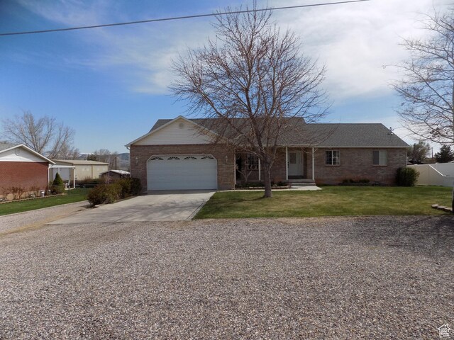 475 W 100 N, Aurora, UT 84620 - ranch-style house featuring a garage, fence, a front yard, brick siding, and concrete driveway
