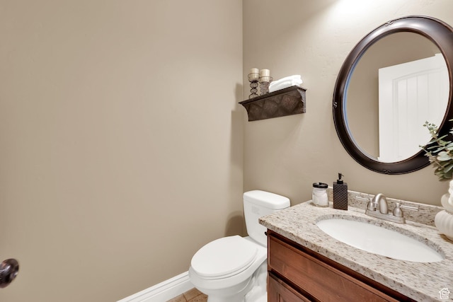 bathroom with toilet and vanity
