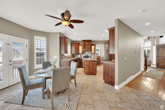 dining room with stone tile flooring, baseboards, recessed lighting, and ceiling fan