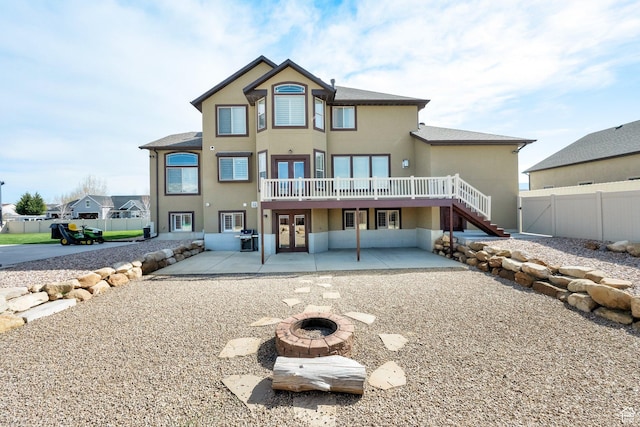 back of house featuring a patio, french doors, stucco siding, and fence