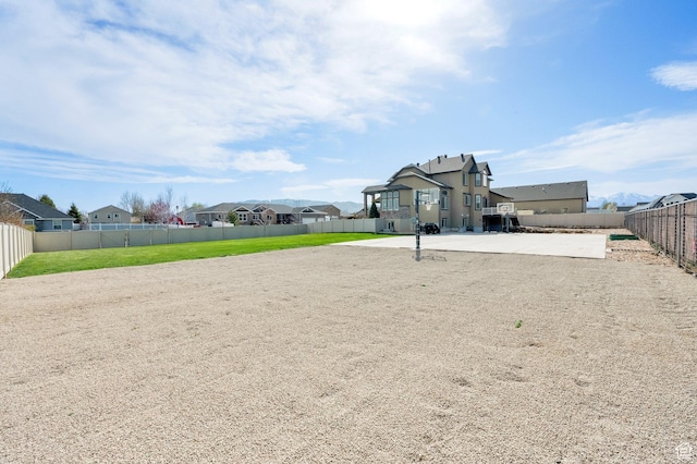 view of yard with a fenced backyard and a residential view