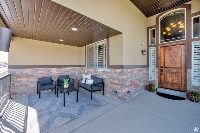 entrance to property with stucco siding and stone siding