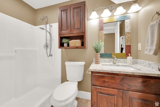 full bathroom featuring vanity, baseboards, a tile shower, and toilet