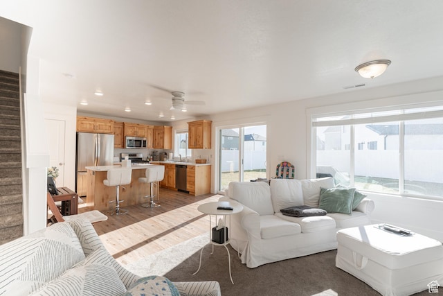 3048 S 400 W, Nibley, UT 84321 - living room featuring visible vents, a ceiling fan, light wood-type flooring, recessed lighting, and stairs