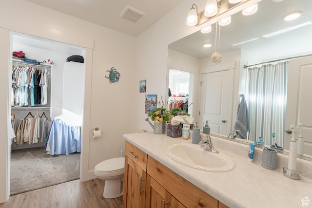 3048 S 400 W, Nibley, UT 84321 - full bath with visible vents, curtained shower, toilet, vanity, and wood finished floors