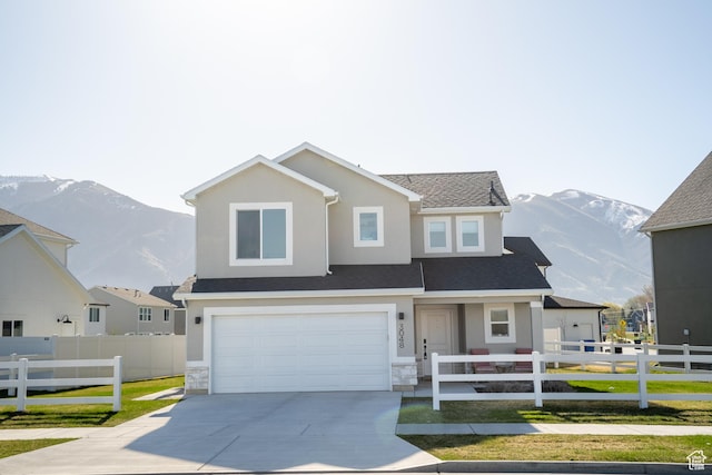 3048 S 400 W, Nibley, UT 84321 - view of front of house with a mountain view, fence, a garage, and concrete driveway