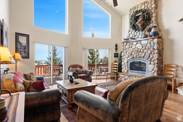 17 Wedge Way, Garden City, UT 84028 - living room with ceiling fan, a towering ceiling, wood finished floors, and a stone fireplace