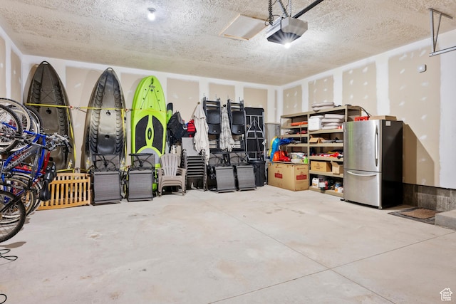 17 Wedge Way, Garden City, UT 84028 - garage featuring freestanding refrigerator and a garage door opener