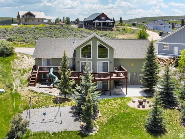 17 Wedge Way, Garden City, UT 84028 - rear view of house featuring a deck, a patio, a fire pit, and a shingled roof