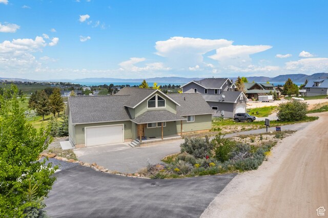 17 Wedge Way, Garden City, UT 84028 - craftsman-style home featuring an attached garage, driveway, a mountain view, and a residential view