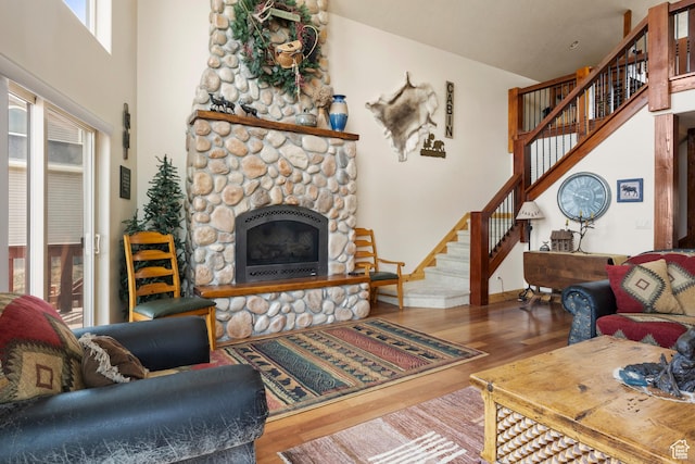 17 Wedge Way, Garden City, UT 84028 - living room featuring wood finished floors, stairway, a fireplace, and baseboards