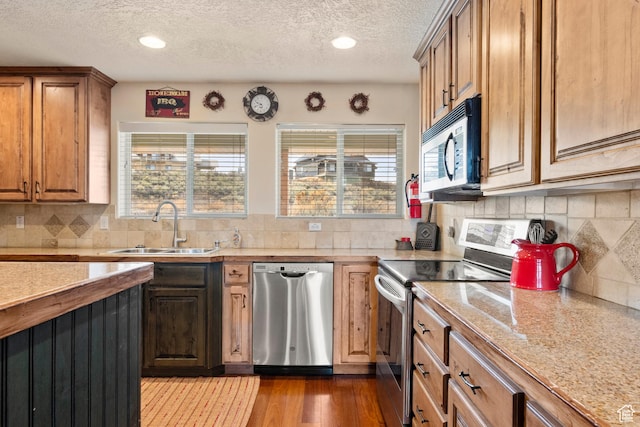 17 Wedge Way, Garden City, UT 84028 - kitchen featuring stainless steel appliances, a sink, healthy amount of natural light, a textured ceiling, and dark wood-type flooring