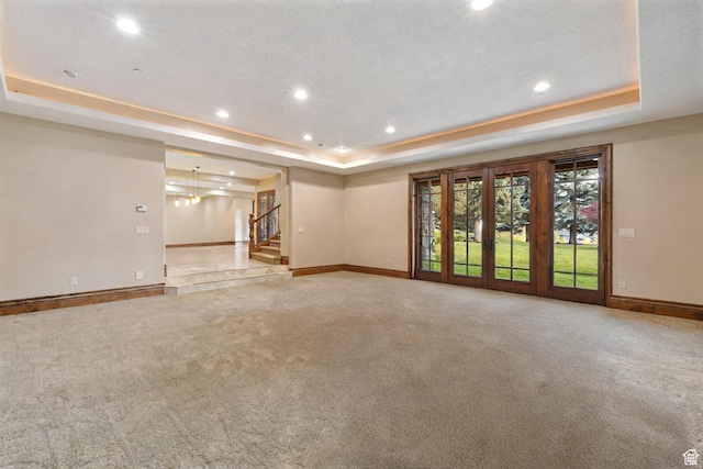 2499 River Meadows Ln, Midway, UT 84049 - spare room featuring a raised ceiling, carpet floors, stairway, and recessed lighting