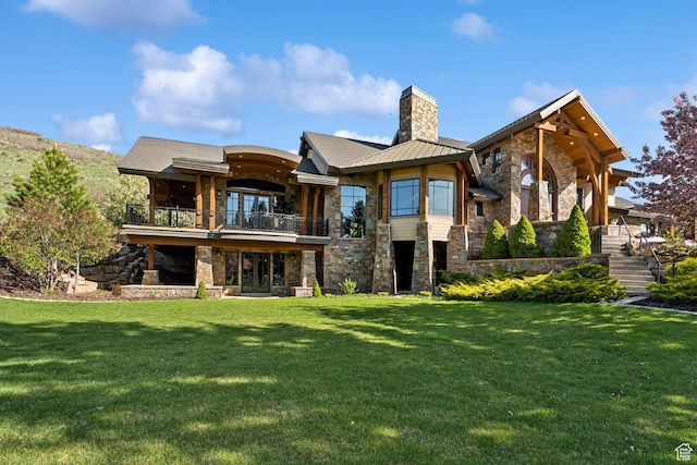 2499 River Meadows Ln, Midway, UT 84049 - back of house with stone siding, a balcony, a chimney, and a yard