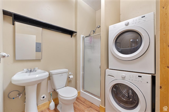 2499 River Meadows Ln, Midway, UT 84049 - bathroom featuring stacked washer / drying machine, a shower stall, and wood finished floors