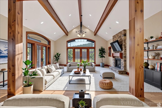 2499 River Meadows Ln, Midway, UT 84049 - living area featuring beamed ceiling, wood finished floors, french doors, a stone fireplace, and high vaulted ceiling