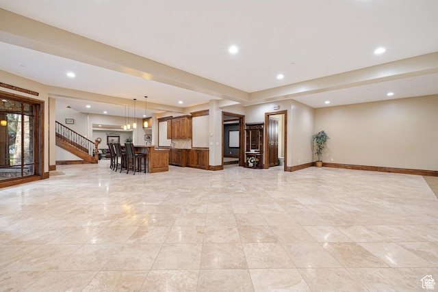 2499 River Meadows Ln, Midway, UT 84049 - kitchen featuring open floor plan, a breakfast bar area, a kitchen island, recessed lighting, and brown cabinets