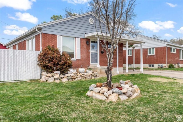 108 W 4300 S, Washington Terrace, UT 84405 - view of front of home with a front yard, brick siding, and fence