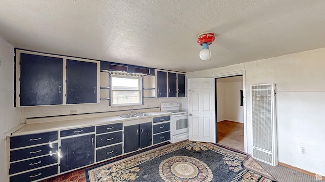 kitchen featuring a sink, white range with electric cooktop, a textured ceiling, a heating unit, and blue cabinets