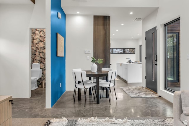 dining room featuring visible vents, recessed lighting, and finished concrete floors