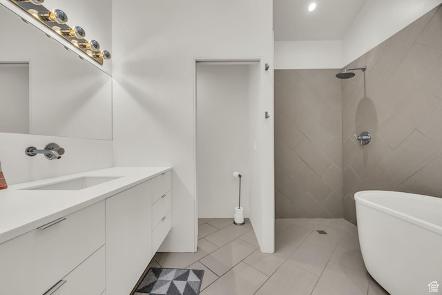 full bathroom with a freestanding bath, tile patterned flooring, vanity, and a tile shower