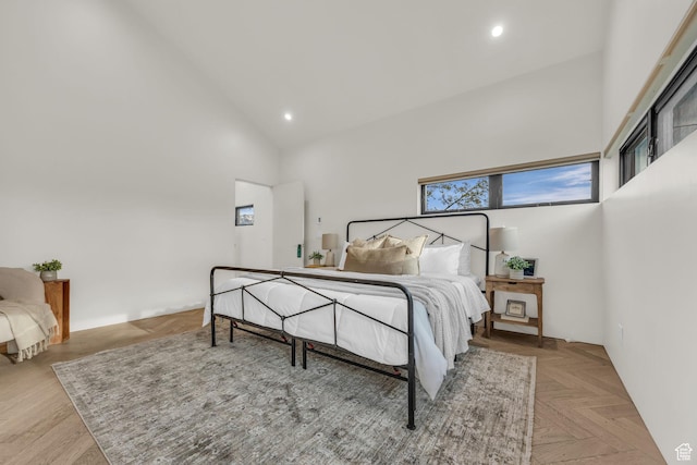 bedroom with high vaulted ceiling and recessed lighting