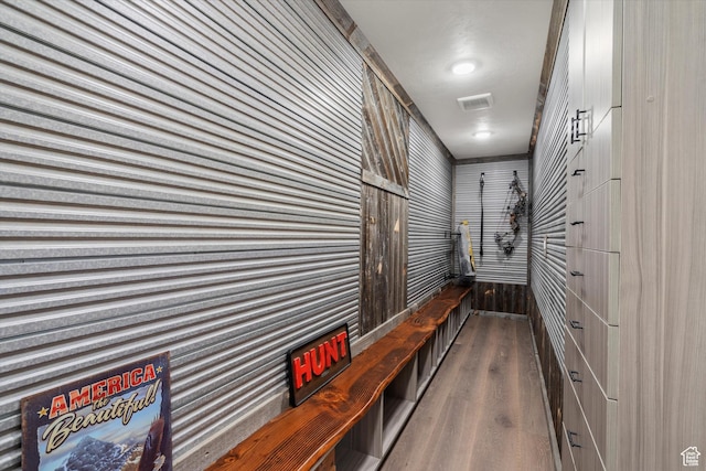 hall featuring visible vents and wood finished floors