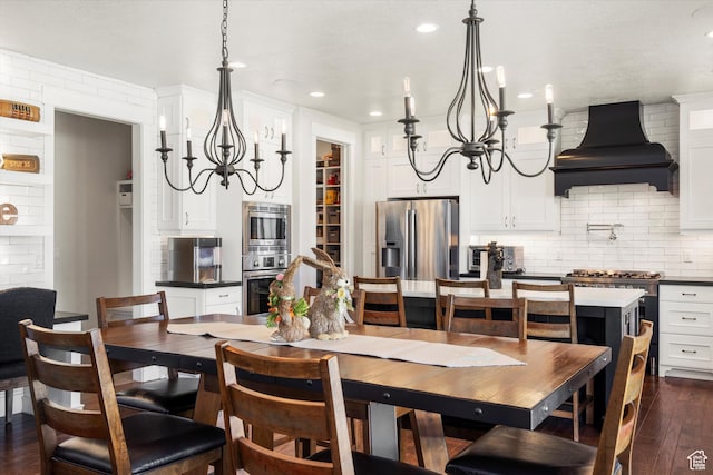dining room featuring a chandelier, recessed lighting, and dark wood-style flooring