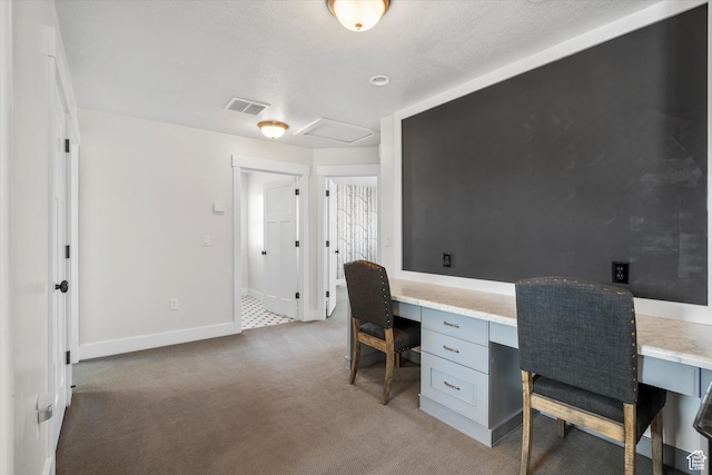 home office with baseboards, carpet flooring, built in study area, and visible vents